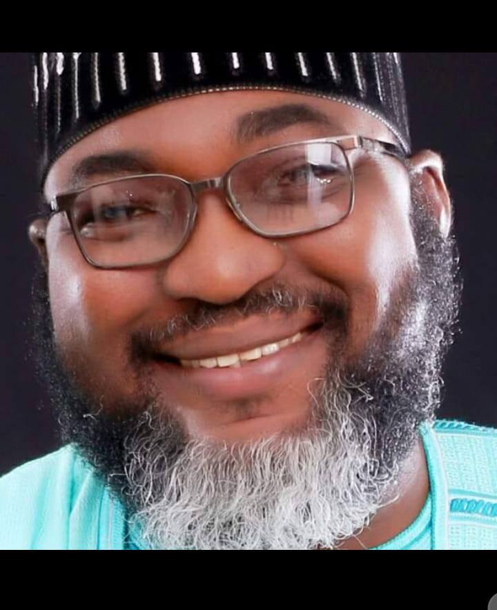 Dr. Adeyemi smiling in traditional attire
